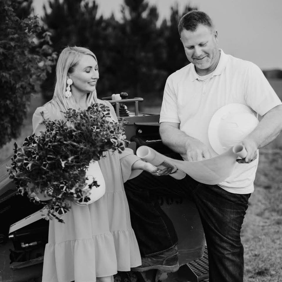 Suzanne and Matt Carden looking over landscape plans together in an original black-and-white photograph