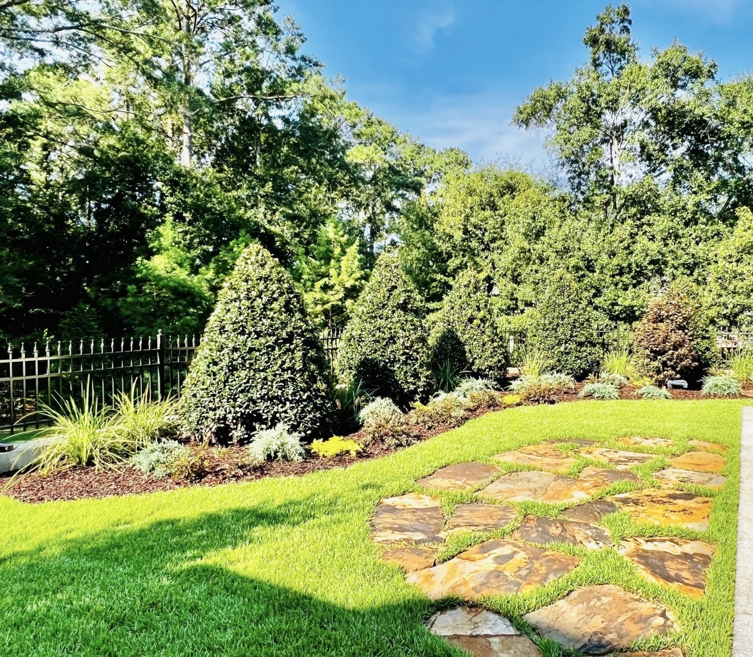 Natural stone path through a planted garden
